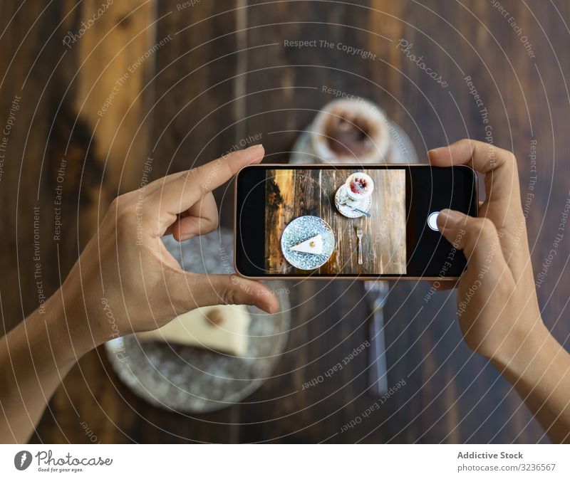Faceless person taking picture of cake and coffee table smartphone photo cup sweet cafe dessert delicious beverage piece eat tasty leisure wooden drink mobile
