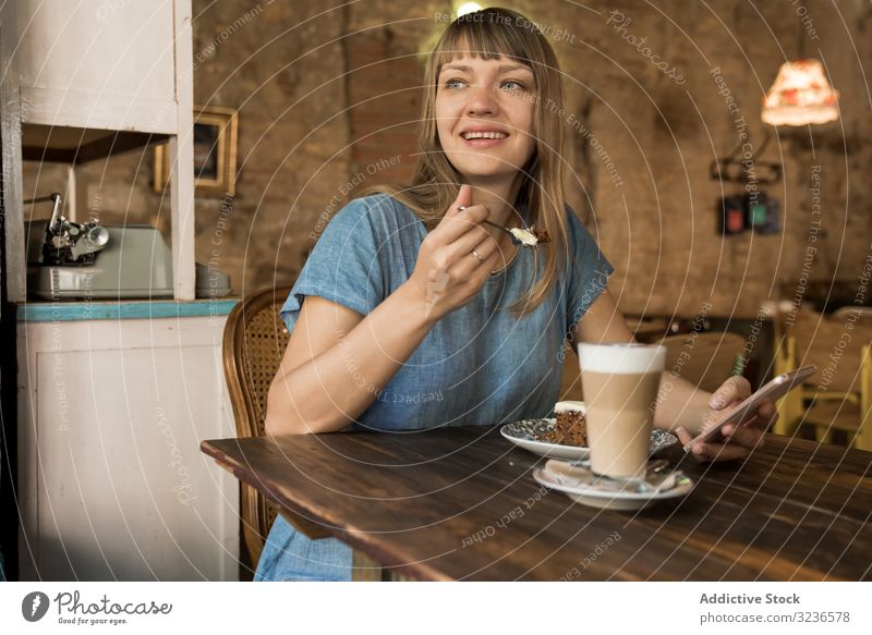 Woman holding spoon with slice of cake woman cafe piece coffee lifestyle young happy female tasty cheerful leisure drink casual try restaurant sitting break