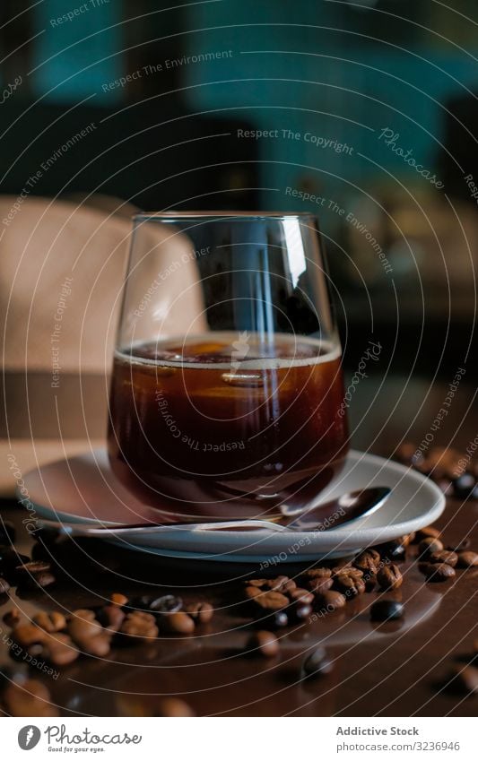 Glass of hot drink in composition with hat and coffee grains on wooden table bean glass beverage refreshment caffeine sweet flavor saucer delicious aroma