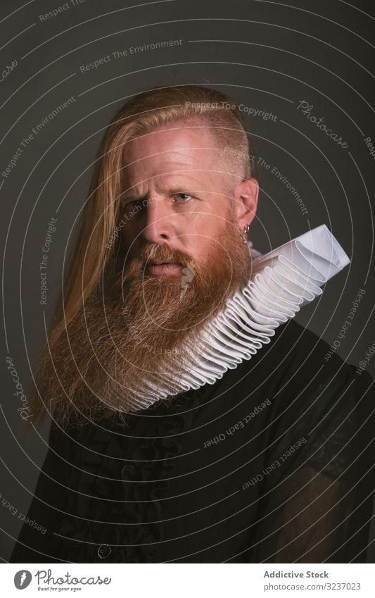 Confident adult red haired medieval magnate looking away ruff confident collar man earl historic beard thoughtful severe nobleman serious pensive independent