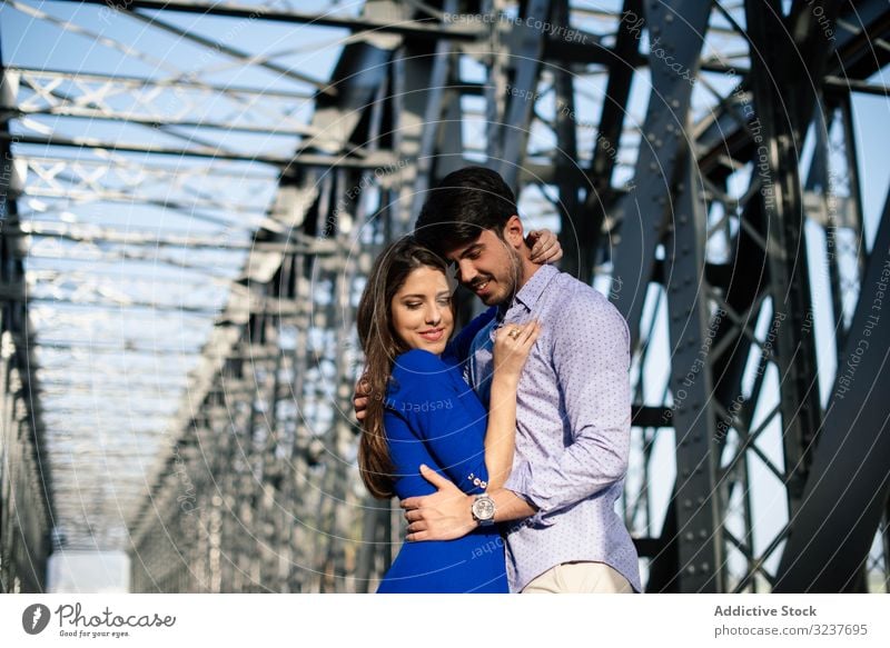 Amorous couple bonding on railway under bridge in love woman industry together architecture road walking romantic relationship close tender support travel