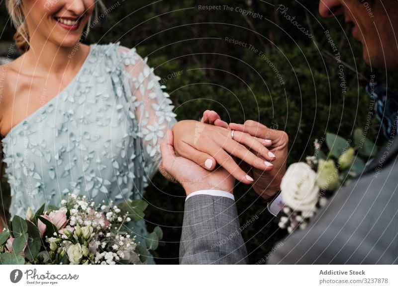 Cheerful newly wedded couple exchanging rings wedding love engagement happiness jewelry wife woman happy ceremony romance together husband marriage celebration