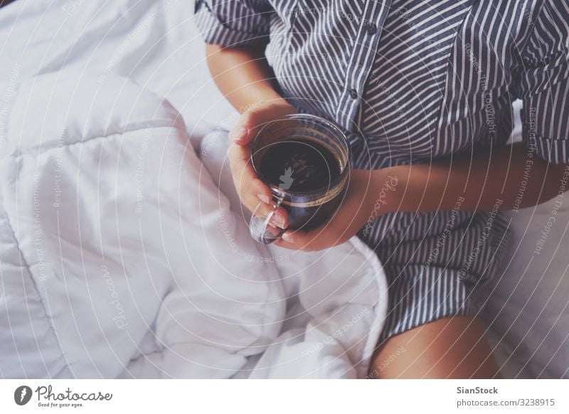 Woman hands holding a cup of hot coffee in bed Coffee Beautiful Life Relaxation Reading Bedroom Adults Hand Book Warmth Natural Cute Above Soft White