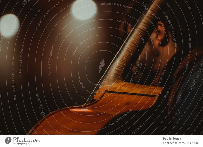 Man playing cello Cello Music Stage Orchestra Concert Colour photo Musician Listen to music Detail Interior shot Art Artificial light Copy Space Close-up Shadow
