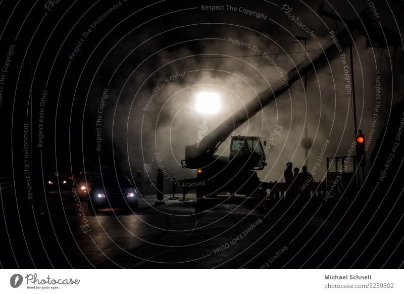 Construction site in the evening Drill Construction machinery Road traffic Street Car Work and employment Back-light Lighting Dark Colour photo Exterior shot