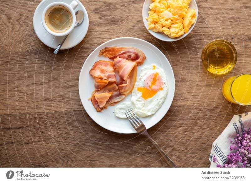 Tasty bacon and eggs with juice at table breakfast food meal served nutrition eating yolk fried healthy variety ingredient fresh appetizing protein tasty pastry