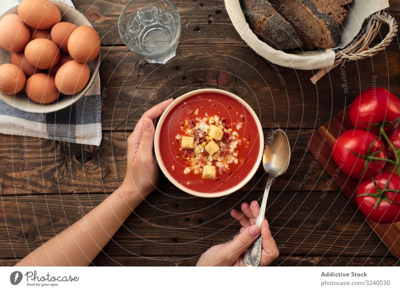Person hands holding bowl with gazpacho soup vegetable gourmet tomato delicious food cuisine eating cold traditional organic from above flat lay copy space