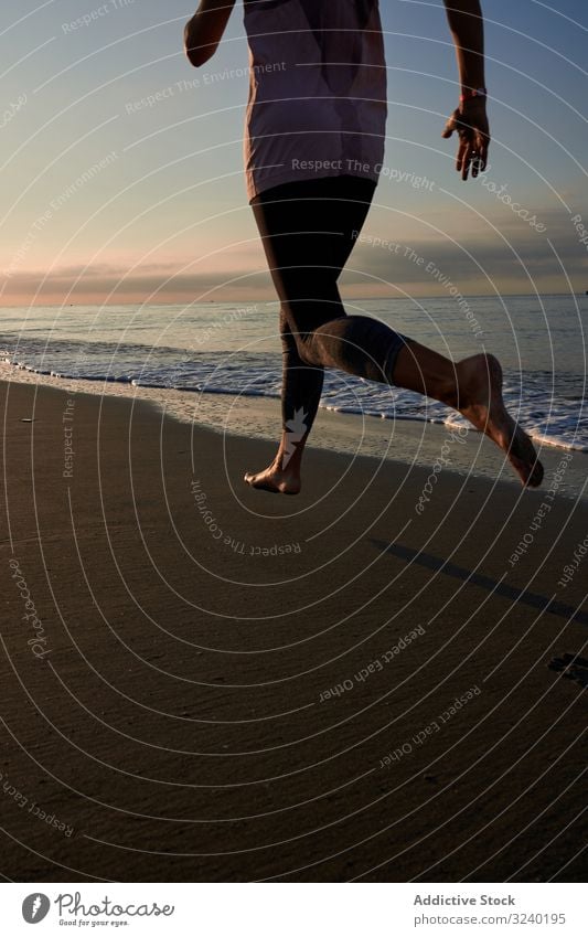 Slim woman jogging on beach run sea evening training fit fitness summer female sport lifestyle athlete barefoot shore coast wave sand water lady cardio athletic