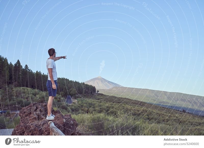 Man pointing away at majestic volcano man location direction island national park grand tenerife spain canary el teide scenic asphalt nature landscape tourism