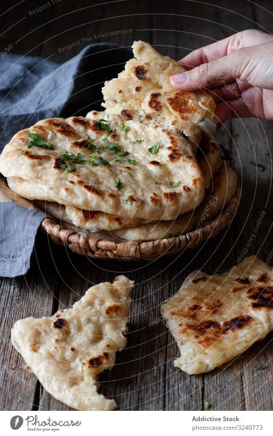 Crop man demonstrating naan bread flatbread rustic show stack fresh food cuisine cooked prepared demonstrate male culinary traditional appetizing tasty