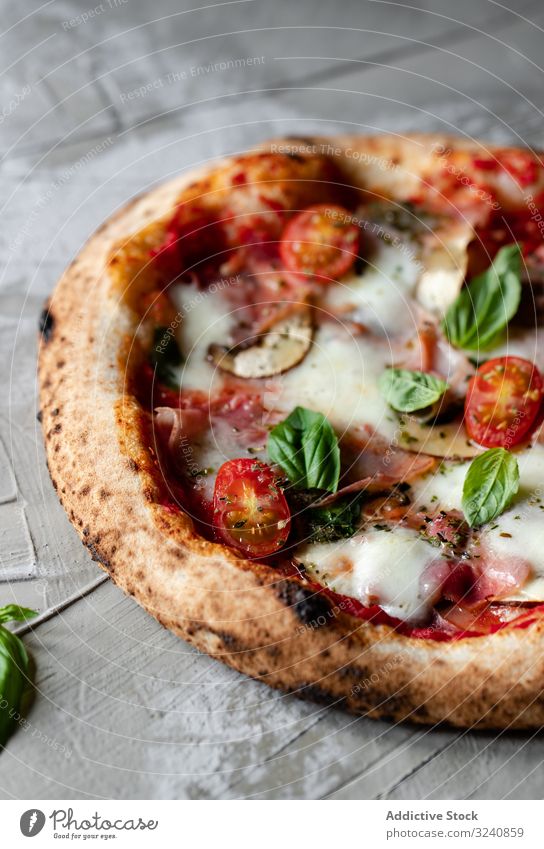 Close up of tasty summer pizza traditional table rustic italian gourmet fresh yummy delicious towel cloth fabric herb basil dinner lunch food appetizing edible