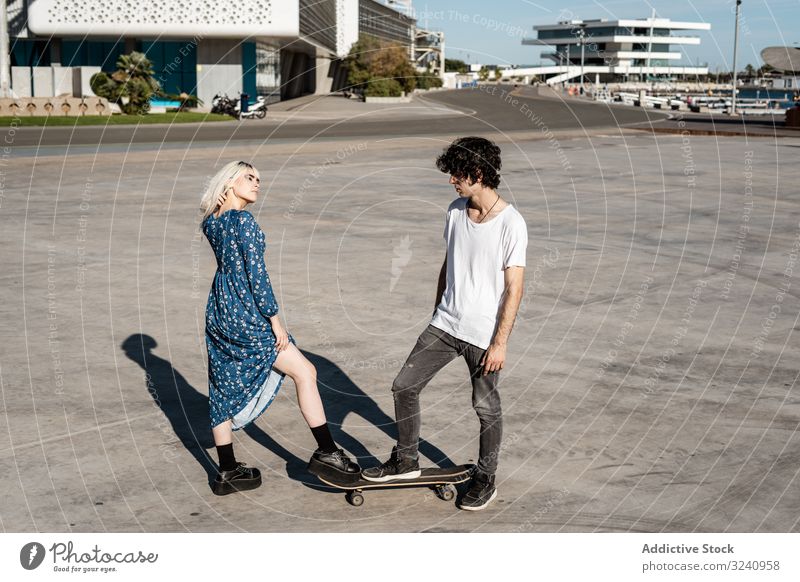 Acquaintance and love at first sight couple acquaintance skateboard confident street concept choice hipster trendy dress attraction calm personality affection