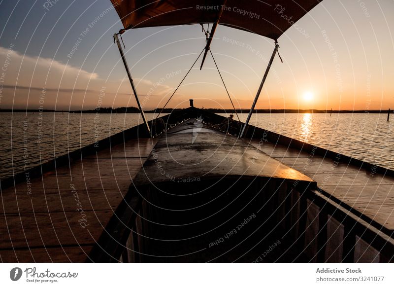 Front of boat riding along sea twilight front evening lagoon valencia ride modern vessel shade float swim smooth ocean dark sunset silhouette detail shadow
