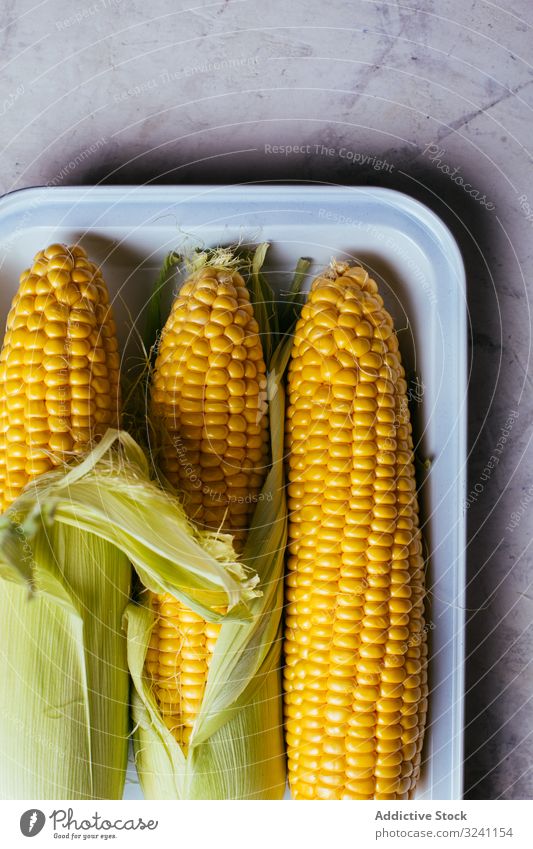 Tray with fresh corn on table peel ripe tray kitchen vegetable food growth agriculture nature marble snack season kernel seed plant healthy edible rustic