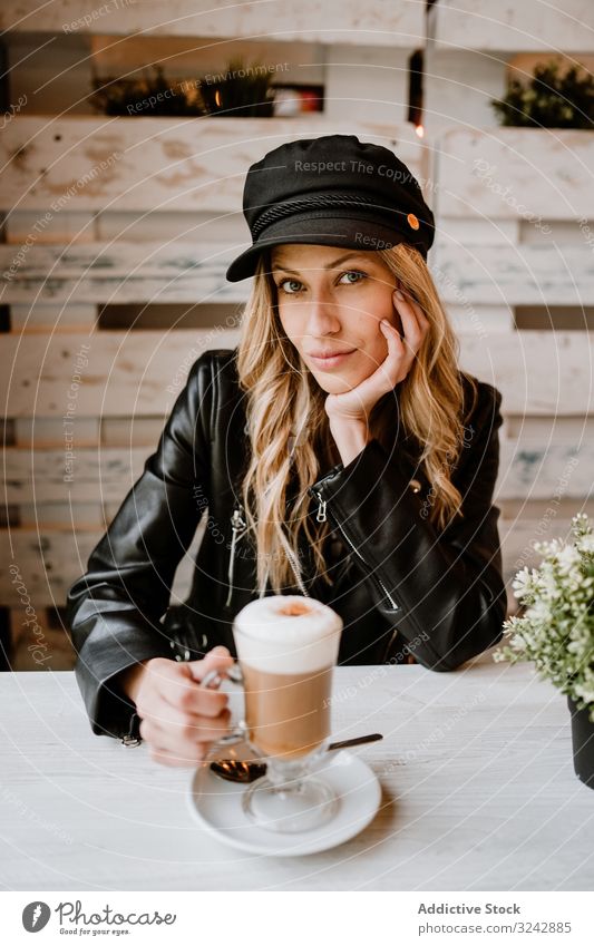 Woman drinking coffee from a glass woman delicious enjoy messy foam cheerful adult sweet cafe tasty cafeteria blonde stylish happy female pleasure contemporary