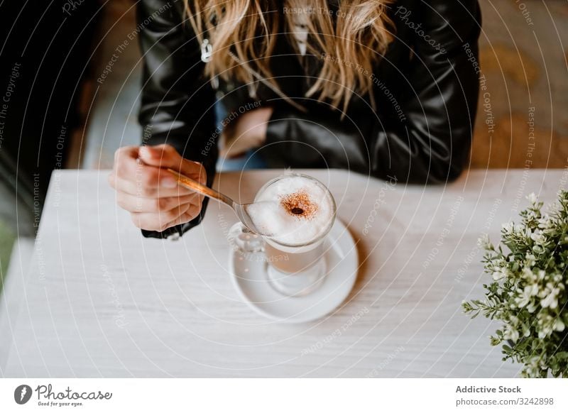 Woman drinking coffee from a glass woman delicious enjoy messy foam cheerful adult sweet cafe tasty cafeteria blonde stylish happy female pleasure contemporary