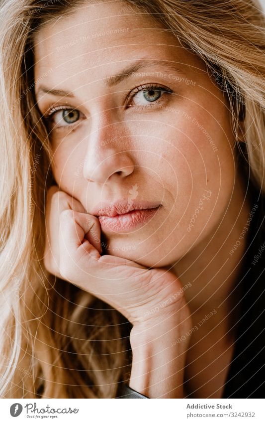 Beautiful blonde woman stylish pensive natural trendy contemplate curly female long haired beauty attractive alone casual romantic charming model smart