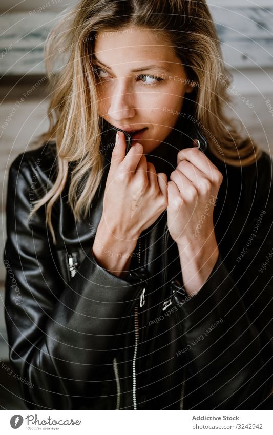 Beautiful blonde woman stylish pensive natural trendy contemplate curly female long haired beauty leather jacket attractive alone casual romantic charming model