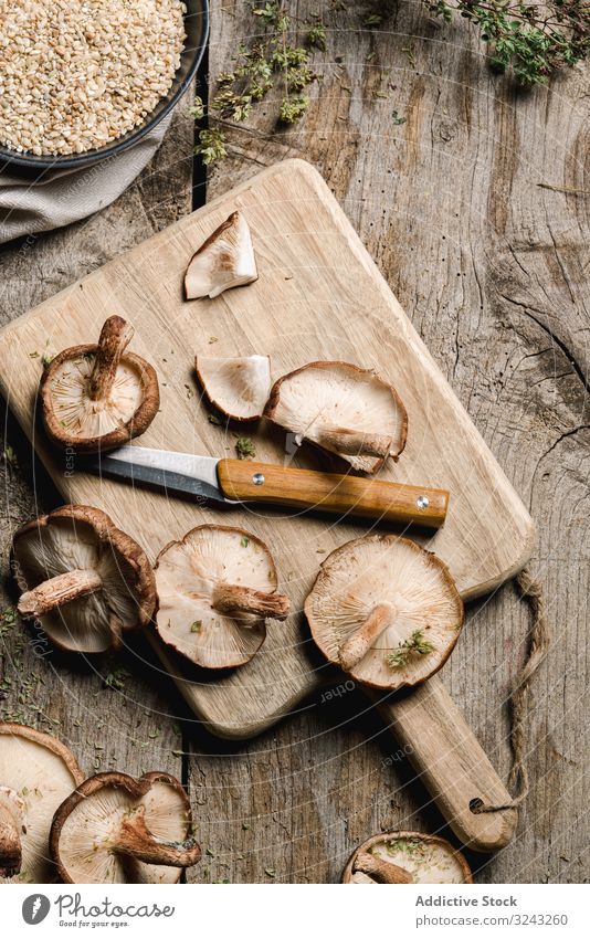 Pile of fresh brown mushrooms on rustic wooden table ingredient knife cuisine cooking nutrition shiitake food meal cultivated metallic fungi botany plant wild