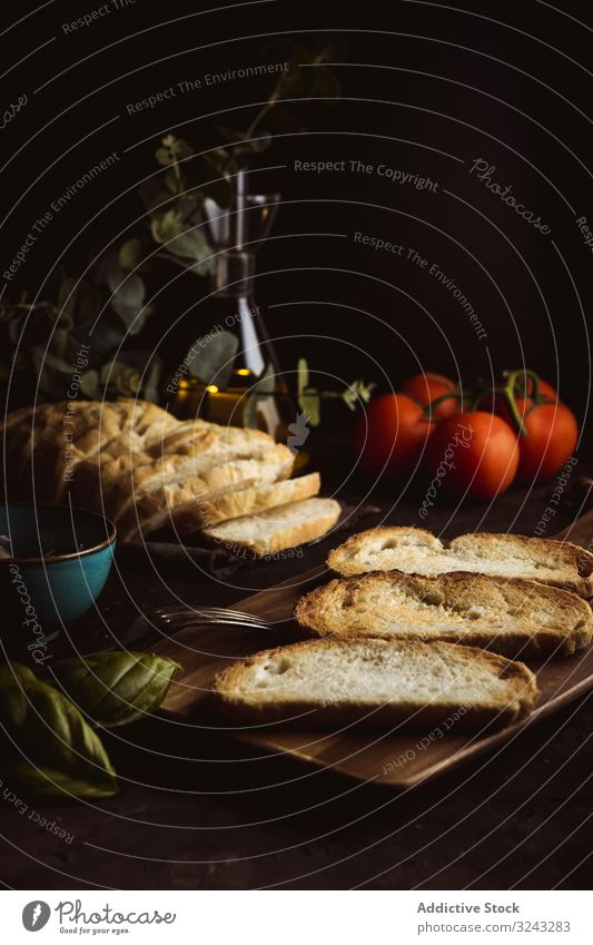Toasts ingredients on dark table toast bread basil tomato food meal fresh rustic traditional dinner lunch delicious tasty bruschetta yummy crunchy crust piece