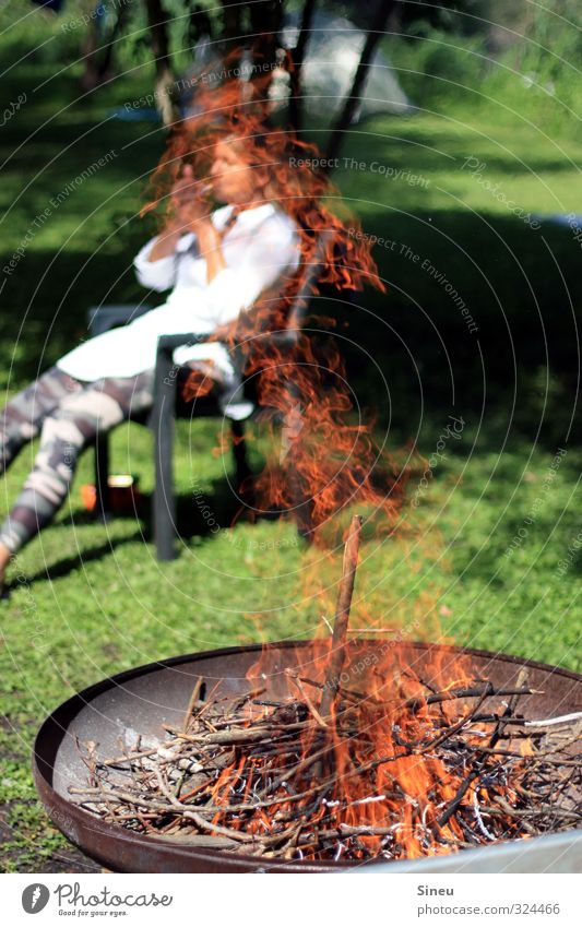 Smoking woman by the fire Smoker Cigarette Fire campfire fire bowl Summer BBQ Garden Weekend relaxation Warmth Wood Burn Burning wood Flame Embers Fireplace