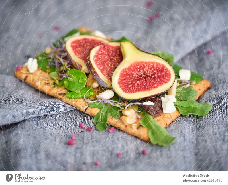 Delicious sandwich with figs and cheese rye bread open sandwich arugula fresh fruit food meal crisp bread vegetable rocket salad refreshment aromatic breakfast