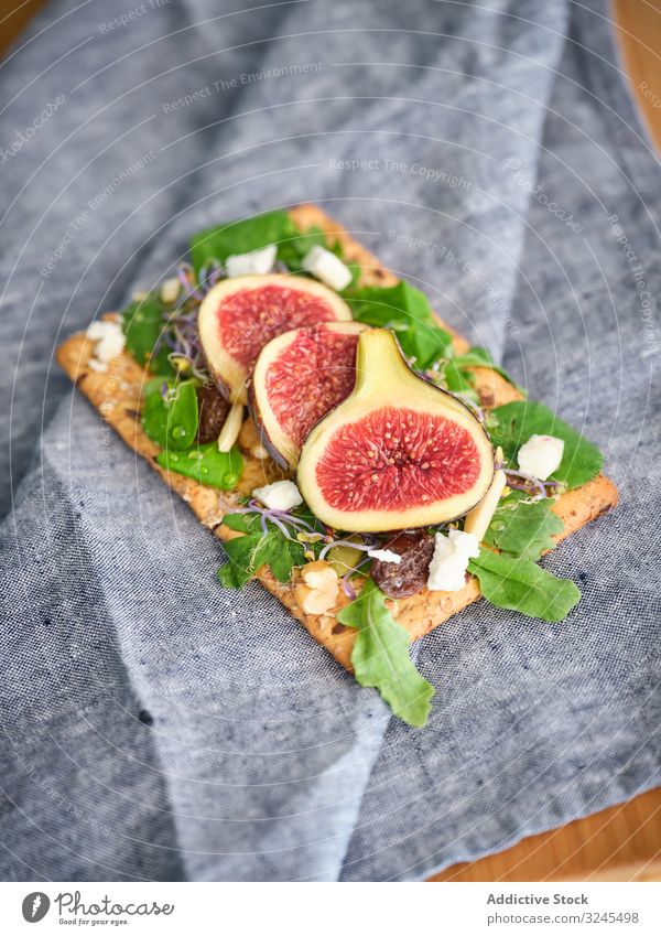 Delicious sandwich with figs and cheese rye bread open sandwich arugula fresh fruit food meal crisp bread vegetable rocket salad refreshment aromatic breakfast