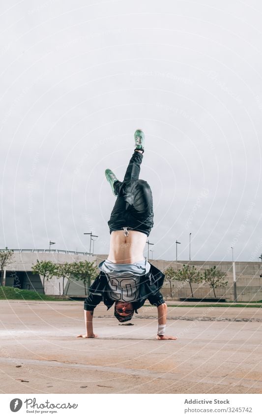 Skillful break dancer performing handstand while moving breakdance cool stylish culture street style lifestyle motion hip hop funky freestyle performance sport