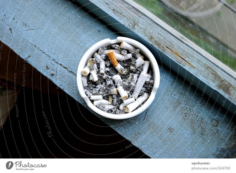 Ashtray full of stubs on a wooden window sill. ashtray adiction cigar cigarette cigarettes smoke smoking