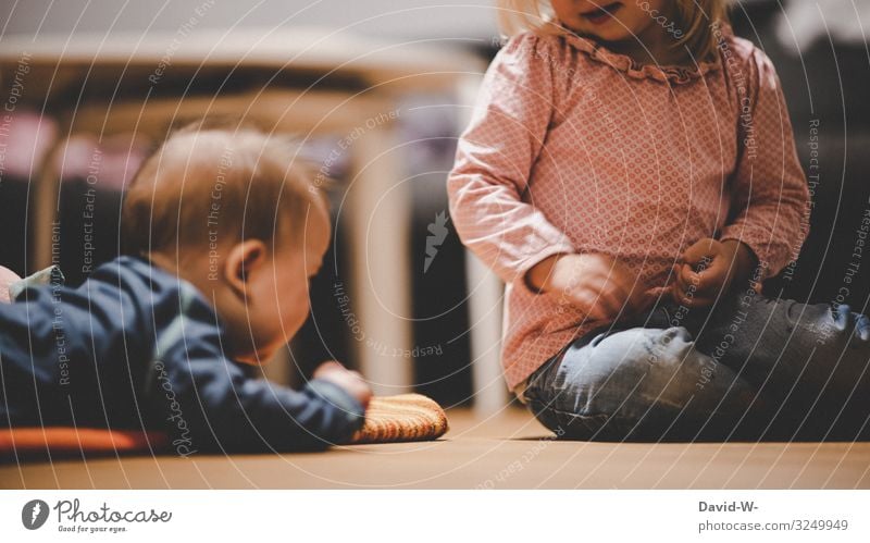 Children play together on the floor children Effortless Playing girl Boy (child) Infancy Brothers and sisters Sister occupy annoy tease sb. Sibling Small