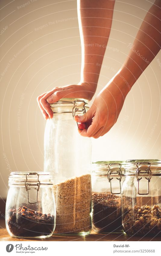 Storage container made of glass sustainable Woman Sustainability grains Preserving jar Glass Glass container Fear of the future Eco-friendly Environment Hand
