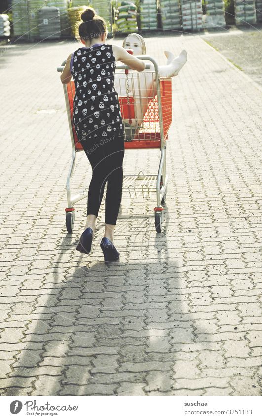 go shopping Girl Child Young woman Youth (Young adults) teenager Shopping Trolley Mannequin Whimsical Funny Strange To go for a walk Joy Push Exterior shot