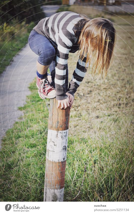 climber (2) Child Girl boyish Climbing Playing Reckless Pole Wooden stake Fence post To hold on Exterior shot Footpath Nature Romp Infancy Dexterity