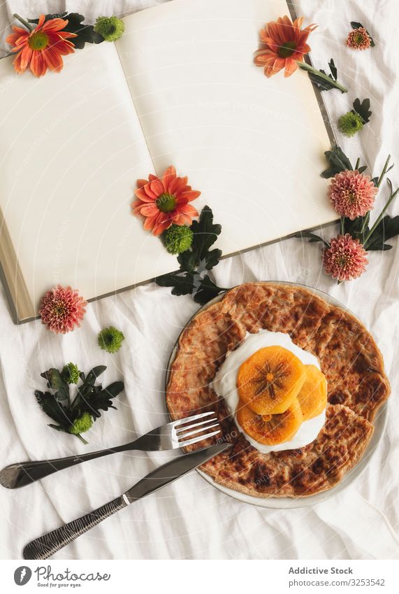 Crepes with cream and persimmon crepe fruit food ruddy dessert tasty fork portion knife book flowers slice delicious plate cloth gourmet appetizing pancake