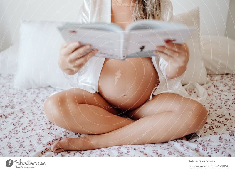 Pregnant woman reading book at home pregnancy maternity sit mother baby belly health young female expect await care lifestyle prenatal parent anticipation tummy