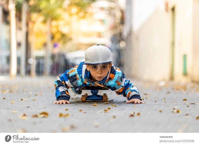 Cute little kid stretched on a skateboard Lifestyle Joy Happy Leisure and hobbies Playing Board game Vacation & Travel Summer Winter Entertainment Sports Child