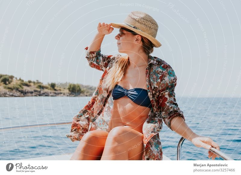 Young woman enjoying a day on the boat Lifestyle Joy Vacation & Travel Tourism Adventure Freedom Cruise Summer Summer vacation Ocean Waves Human being Feminine