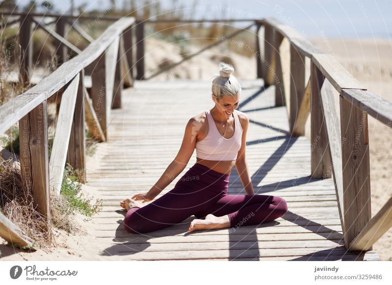 Caucasian blonde woman practicing yoga in the beach Lifestyle Beautiful Body Relaxation Meditation Summer Beach Ocean Sports Yoga Work and employment