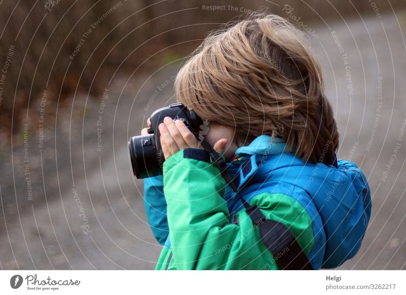 Profile shot of a little boy with half-long hair, looking into a camera Camera Human being Masculine Child Infancy 1 3 - 8 years Nature Winter Clothing Jacket