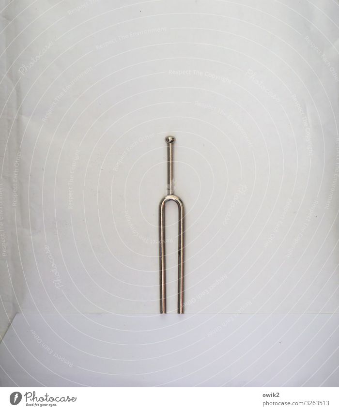 Out of tune Music tuning fork Cardboard Mat Lie Simple Glittering Small Moody Patient Calm Loneliness Colour photo Subdued colour Interior shot Deserted