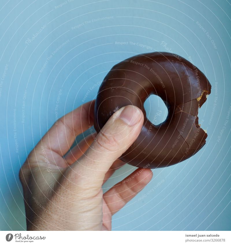 hand with a delicious chocolate doughnut Hand Donut Food photograph Chocolate Tasty Delicious Sweet Fingers body part Blue pastries Saturated fats Dessert