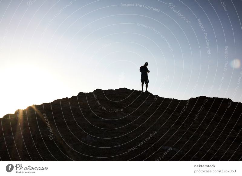 Silhouette of Man Atop a Hill in Atacama Sunrise Adults Nature Sky Beautiful weather Rock Discover Walking Hiking Andes Mountains panorama 1 Person Chile