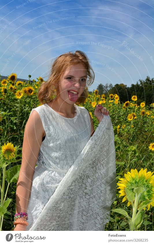 Girl stands in a field of sunflowers and sticks out her tongue Lifestyle Joy Trip Summer Human being Feminine Young woman Youth (Young adults) 1 13 - 18 years