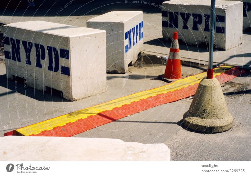 construction site Traffic infrastructure Gray Barrier Warn Hat Construction site Police Force Colour photo Exterior shot Light Shadow Contrast