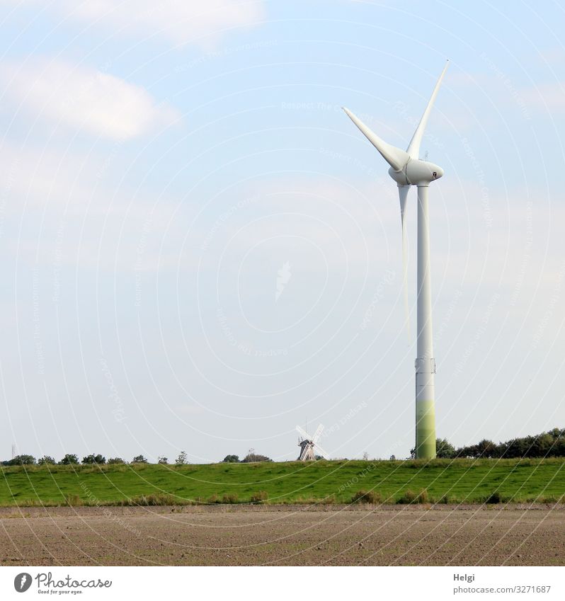 Size difference between wind turbine and historical windmill Energy industry Renewable energy Wind energy plant Environment Nature Landscape Plant Sky Clouds