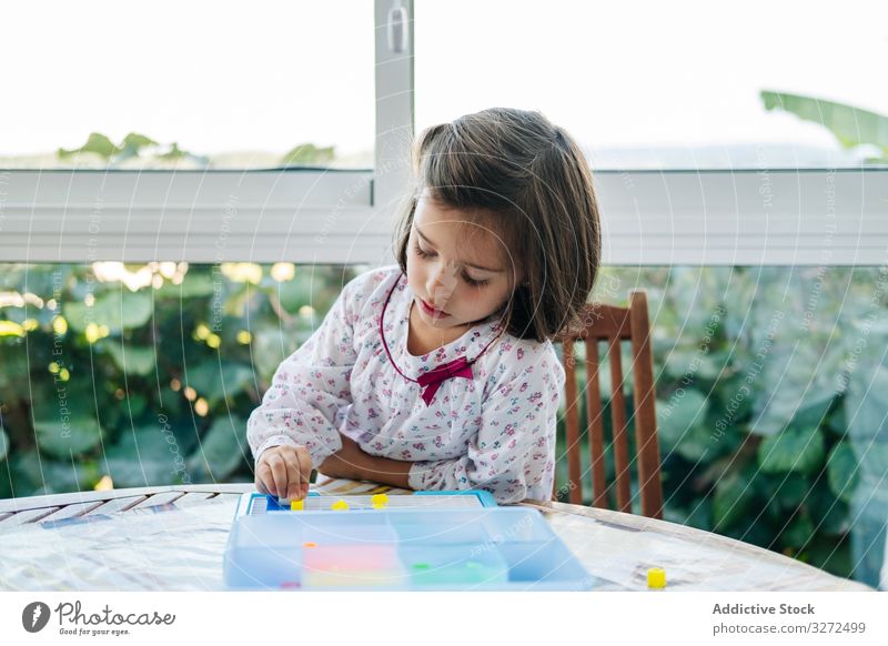 Girl playing with mosaic board game girl creative focused concentration piece colorful concentrate education puzzle assemble fun child childhood kid little
