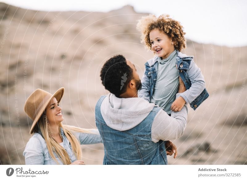 Happy multiethnic family gathering on nature fun parent toddler play rest sand smile happy cheerful lifestyle modern child man bonding love tender casual kid