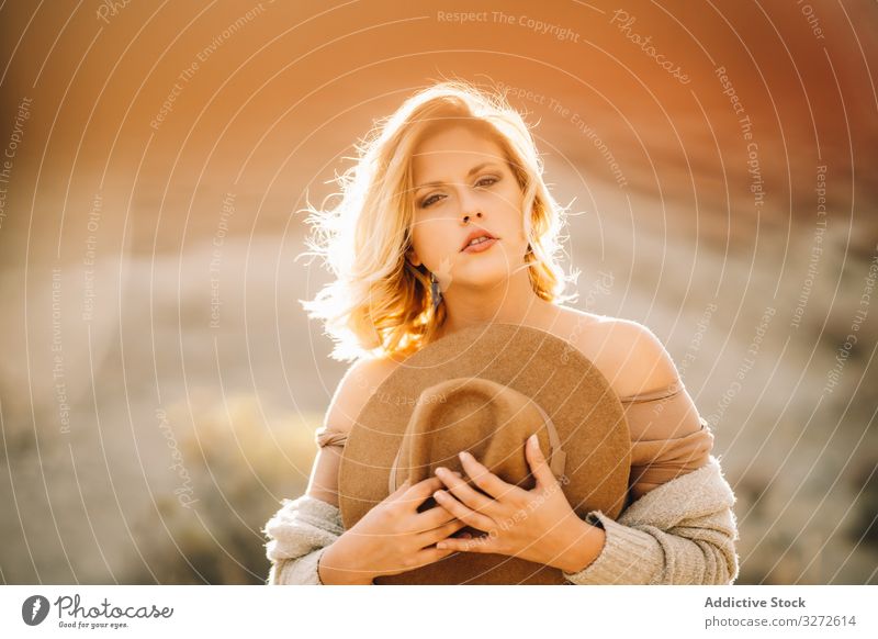 Tender woman holding straw hat on nature tender portrait graceful wind blonde quiet calm peaceful romantic sit charming female appearance dreamy flawless