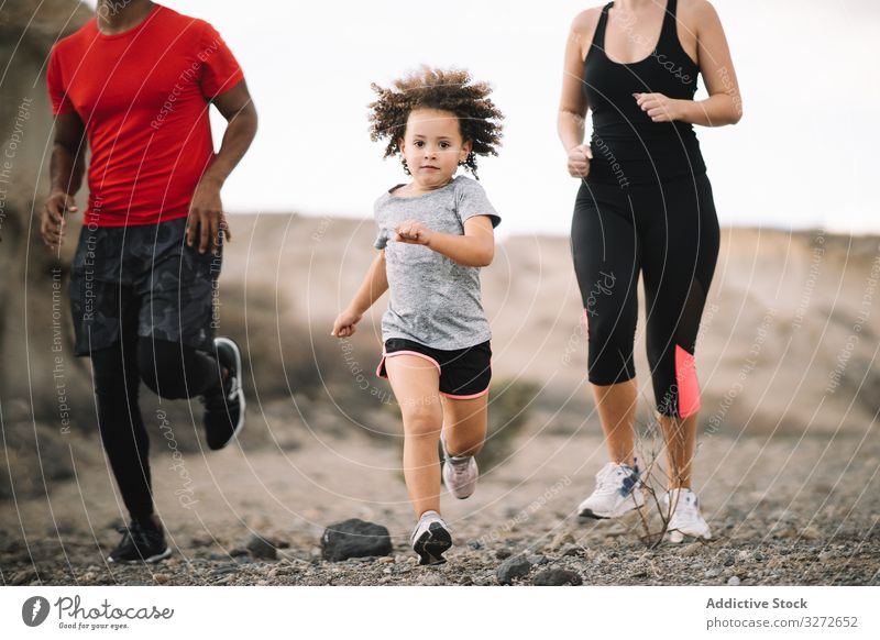 Active diverse family running on nature sportive active smile desert morning lifestyle together support health dynamic jogging multiethnic multiracial fitness