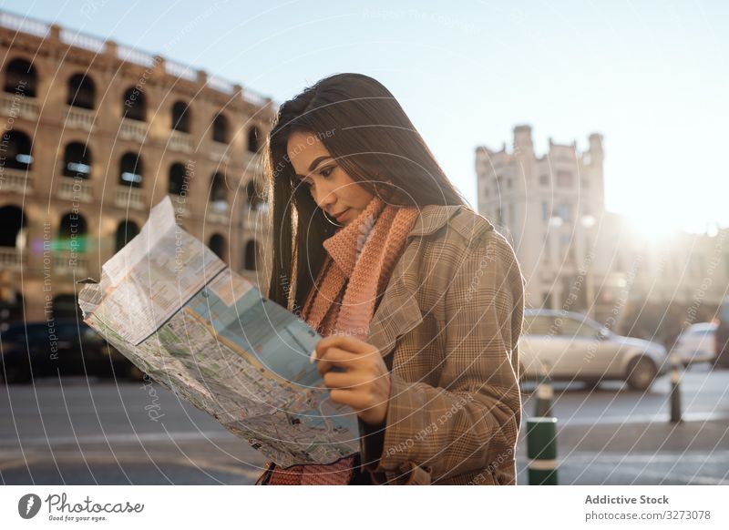 Asian tourist reading map in city woman ethnic sightseeing historic vacation guide female asian sunny daytime examine route location destination journey travel